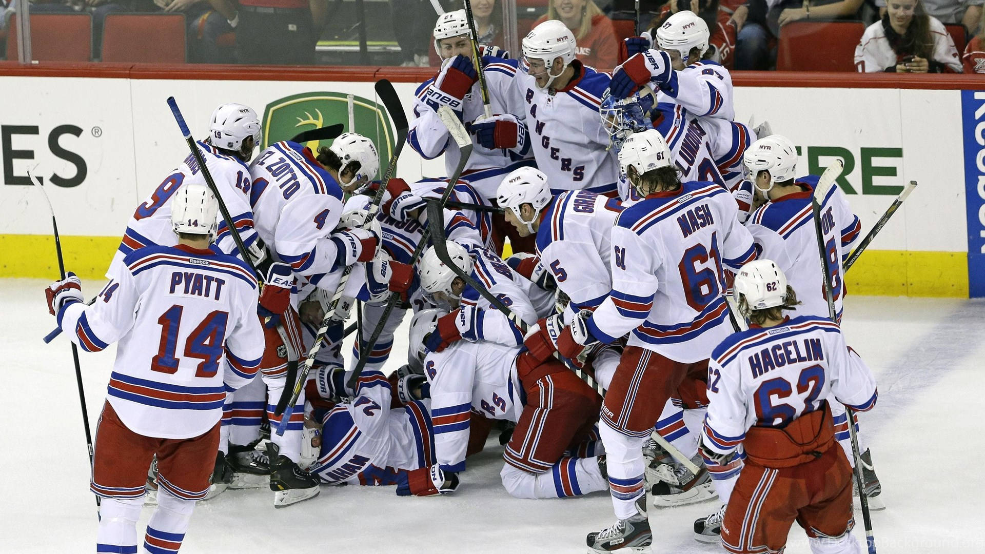 New York Rangers players celebrating a goal on the ice