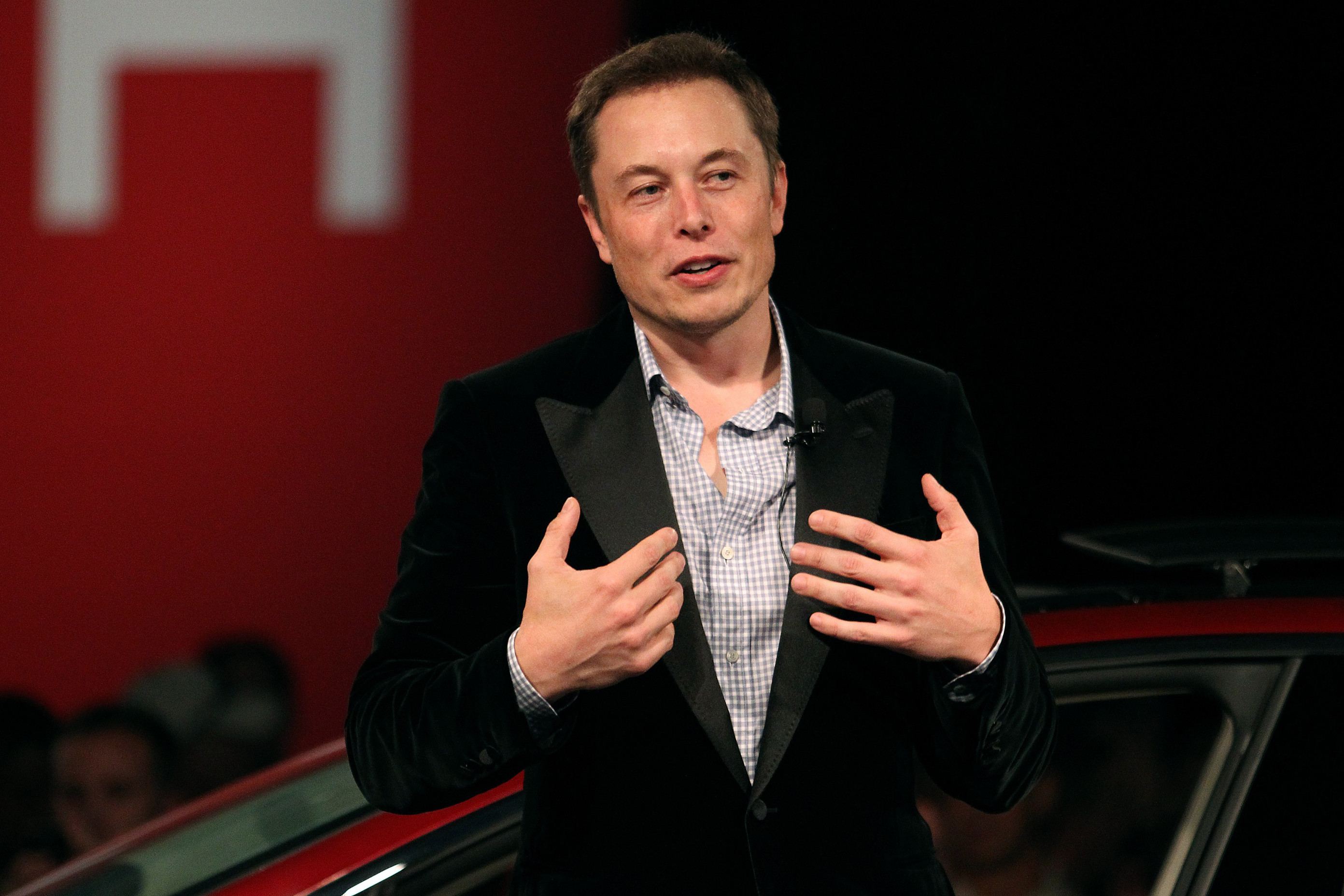 Elon Musk speaking at a Tesla event
