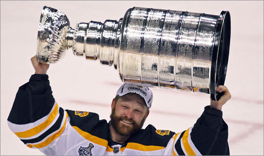 The Ice With Stanley Cup Hoisted Above His Head After Bruins