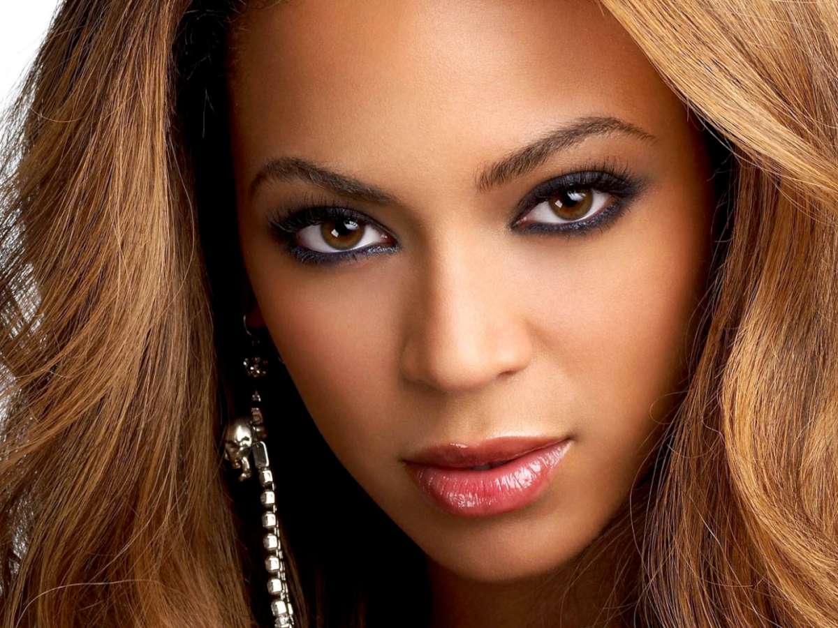 Close-up headshot of Beyoncé, highlighting her captivating gaze and radiant complexion