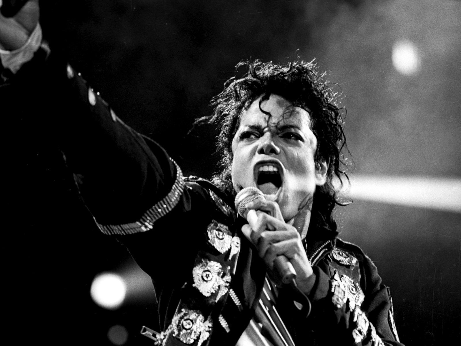 Michael Jackson performing on stage with a microphone in his hand