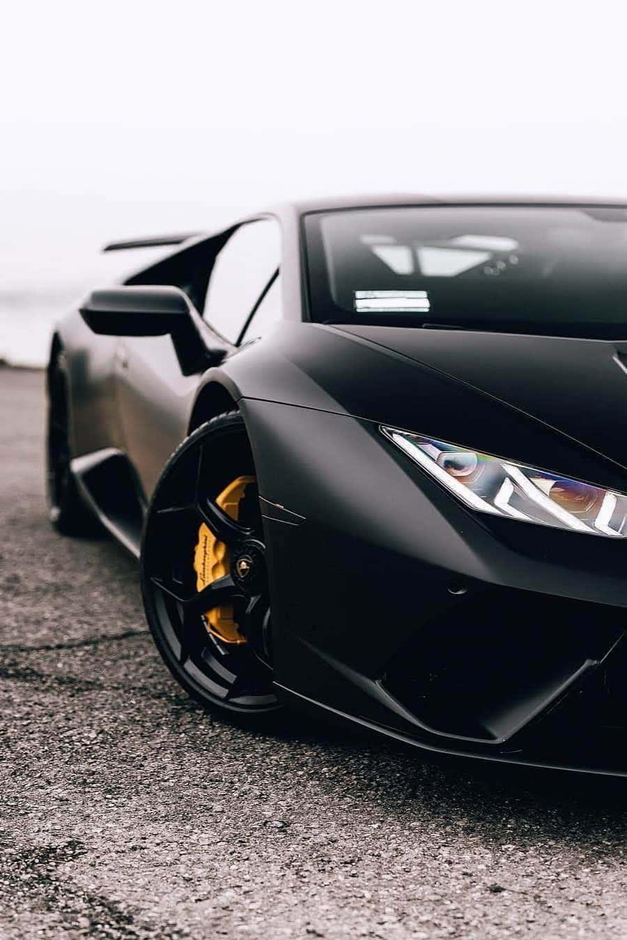 A Black Lamborghini Parked On The Side Of Road