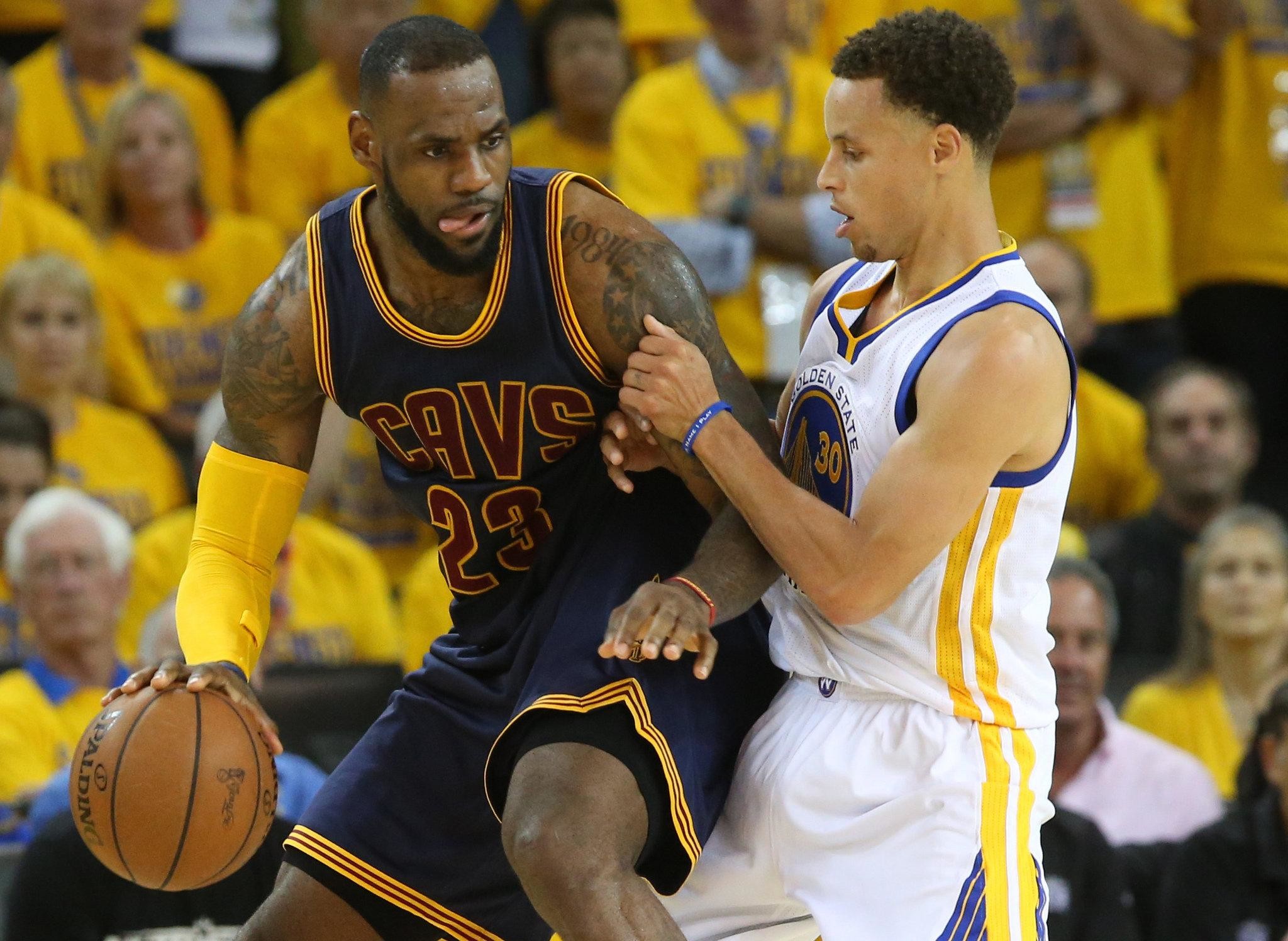 LeBron James and Stephen Curry battling for possession during an NBA game