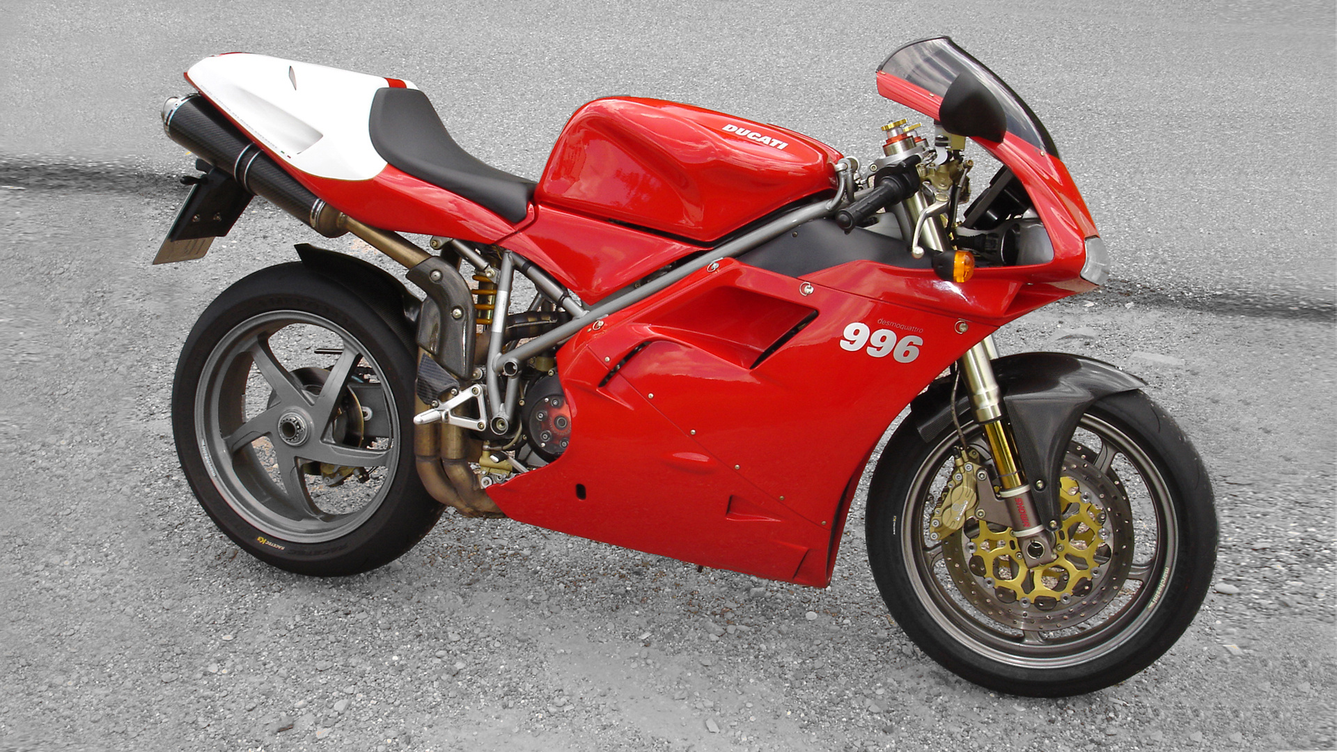 Ducati 996 sportbike in red and white, parked on a paved surface
