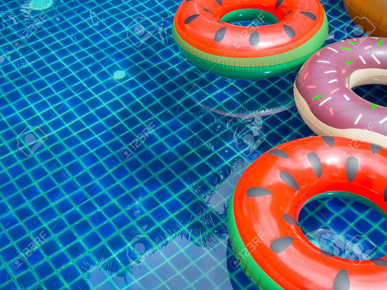 Free download Colorful Pool Float Rings Are Floating On Swimming Pool