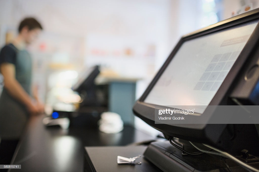 Closeup Of Checkout Counter With Cashier In Background At Coffee