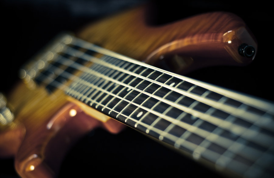Close up of bass guitar player grooving on stage 4K wallpaper download
