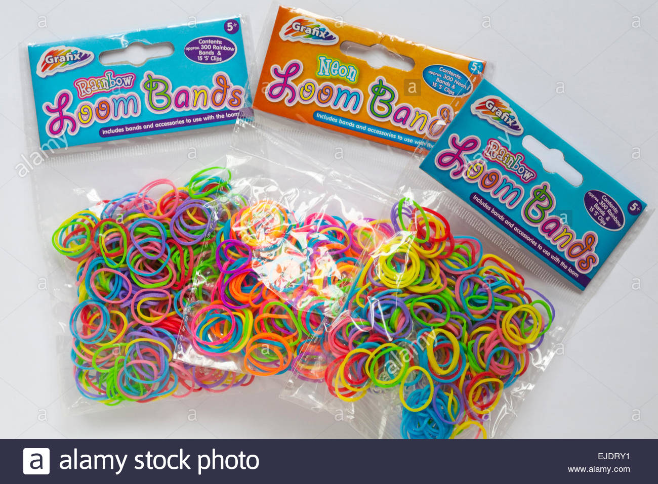 Packets Of Grafix Neon And Rainbow Loom Bands Set On White
