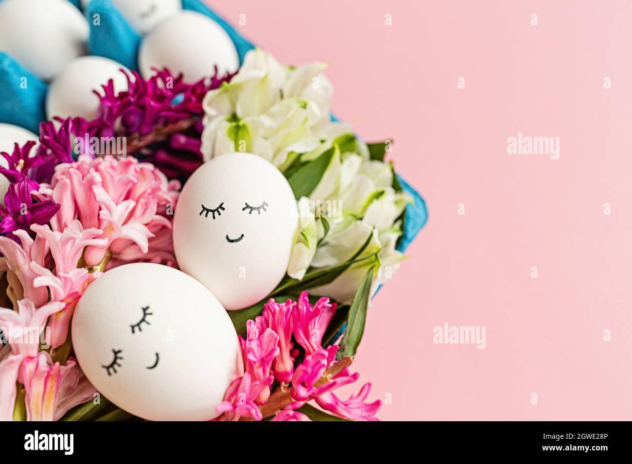 Creative Easter Eggs With Cute Face And Sleepy Eyes On Pastel Pink