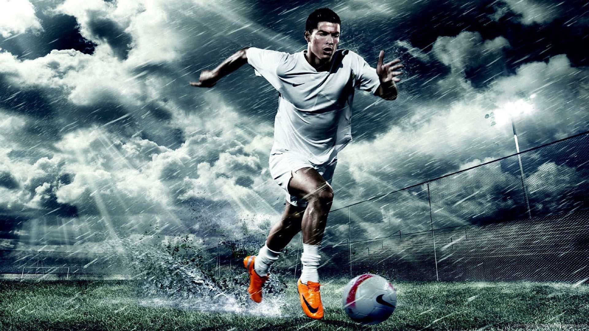 Cristiano Ronaldo dribbling a soccer ball in the rain on a field