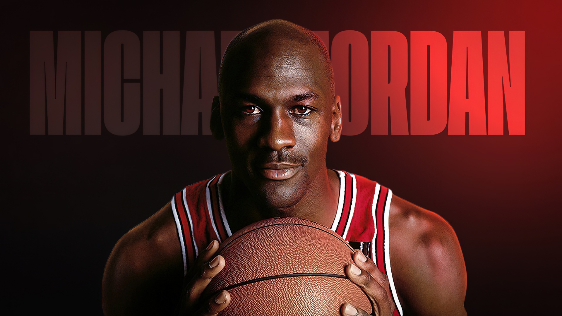 Michael Jordan holding a basketball in a Chicago Bulls jersey