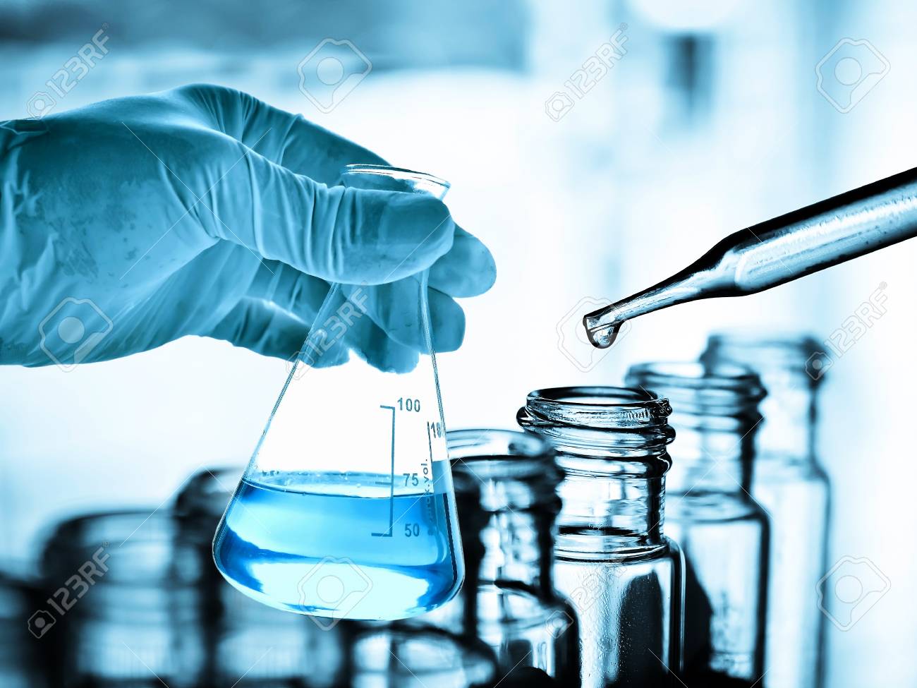 Flask In Scientist Hand With Laboratory Background Stock Photo