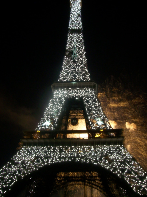 Eiffel Tower Which Is Sparkling With A Firework In The Background