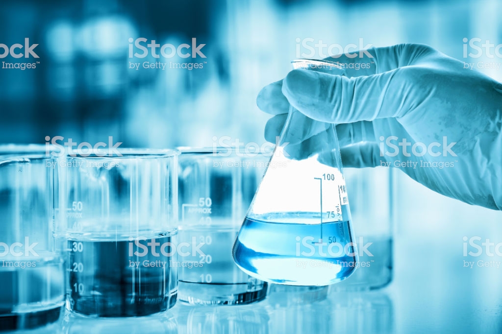 Hand Of Scientist Holding Flask With Lab Glassware In Chemical