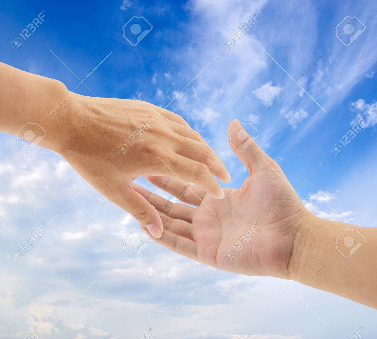 Helping Hands On Sky Background Stock Photo Picture And Royalty