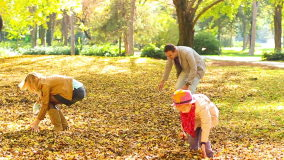 Slow Motion Shot Of Family Throwing Leaves Into Air HD Stock Video