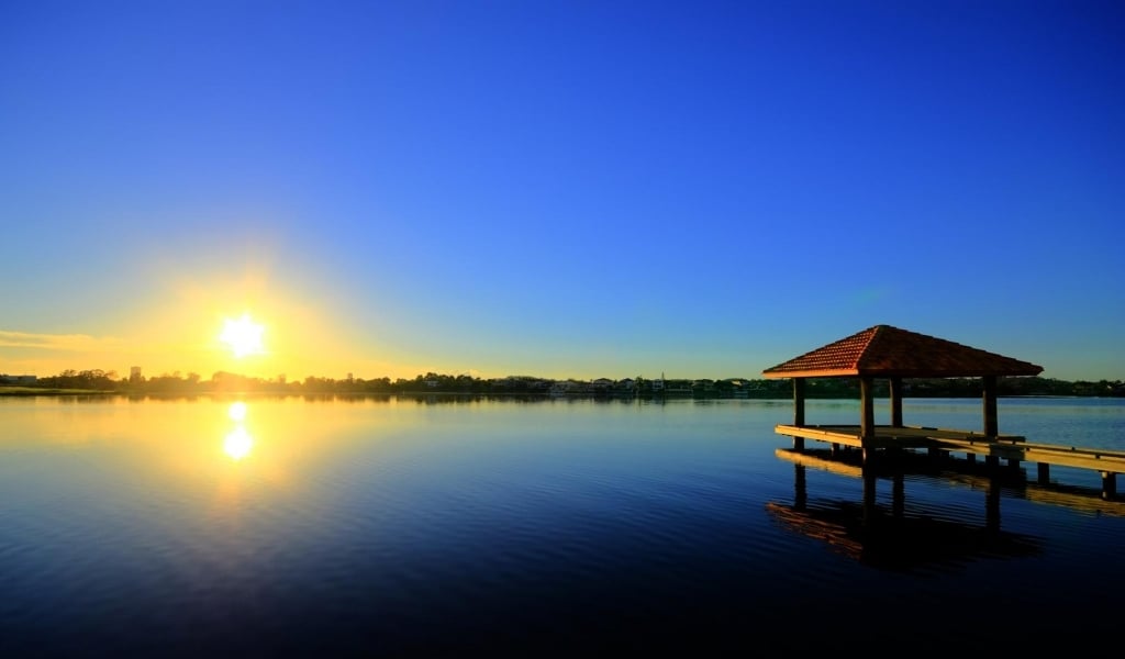 Beautiful sunrise on a peaceful lake wallpaper