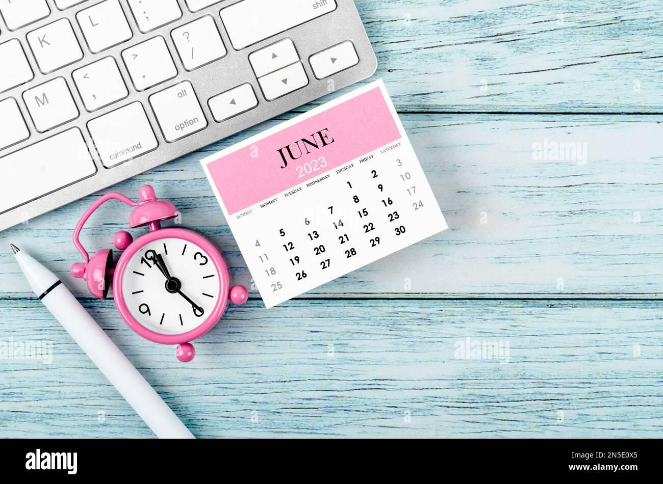 June 2023 Monthly calendar year and alarm clock with keyboard