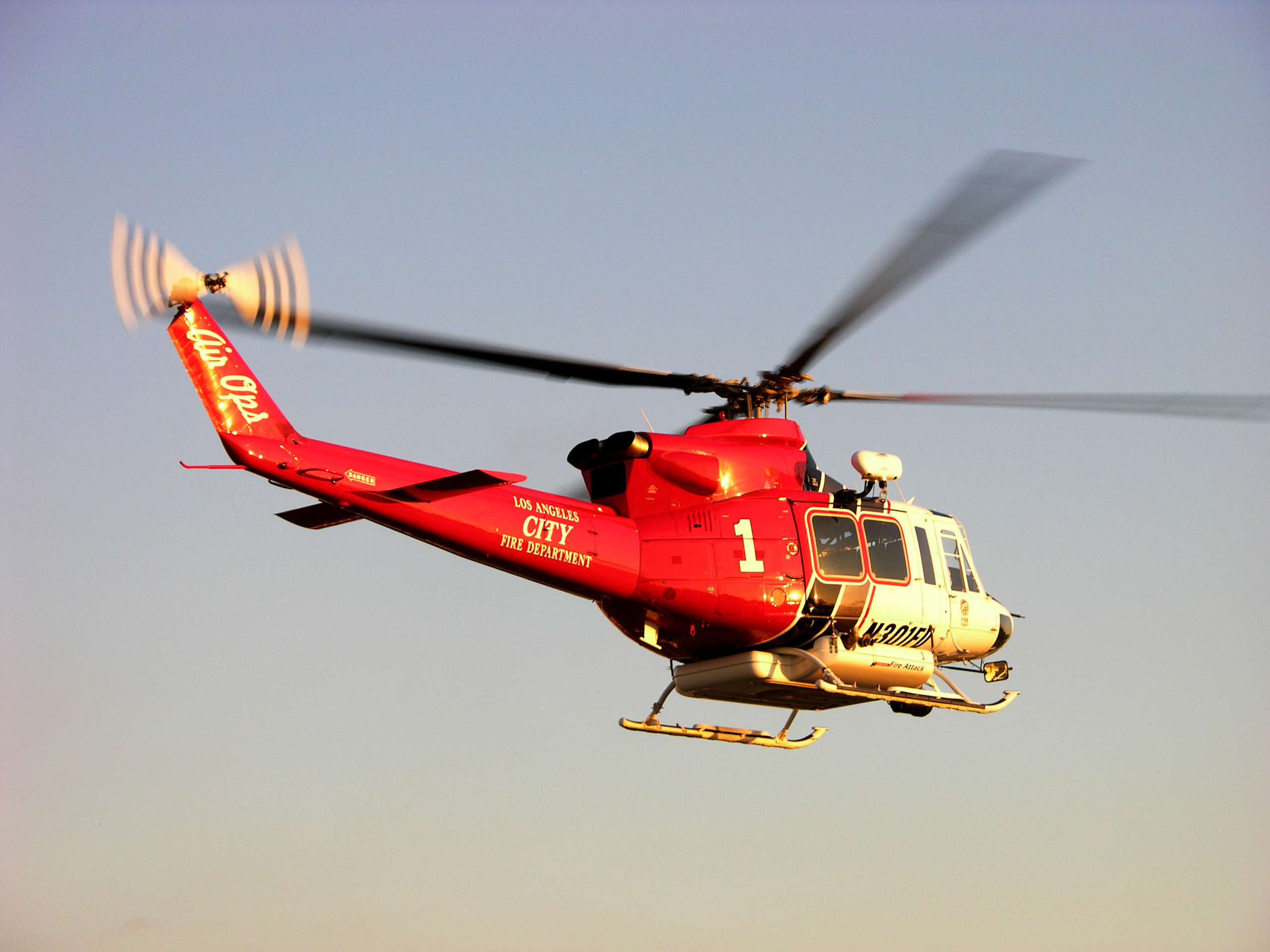 A Los Angeles Fire Department helicopter in flight against a clear sky