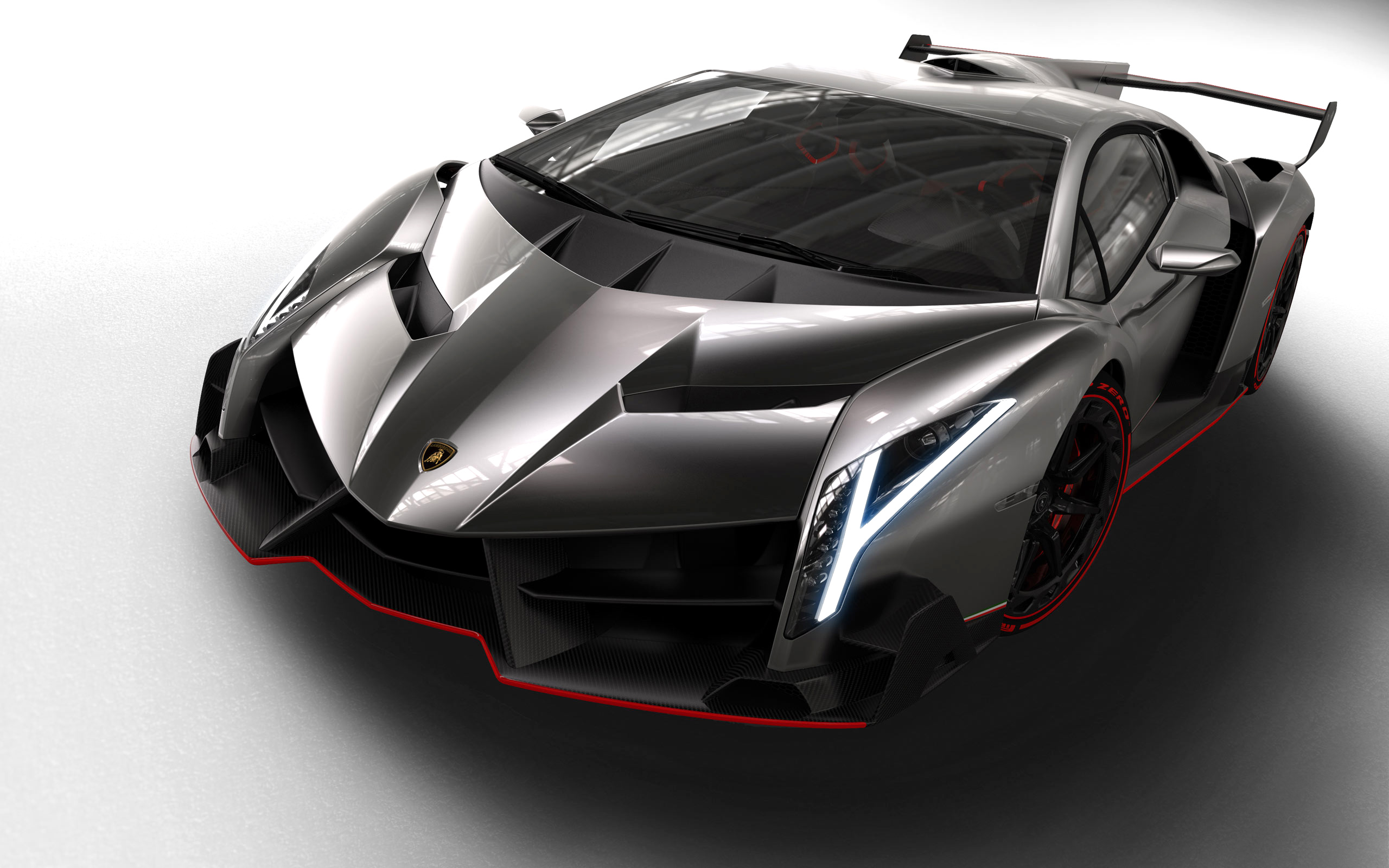 A sleek, futuristic silver Lamborghini Veneno supercar with red accents, parked on a white studio background, showcasing its aerodynamic design and aggressive styling