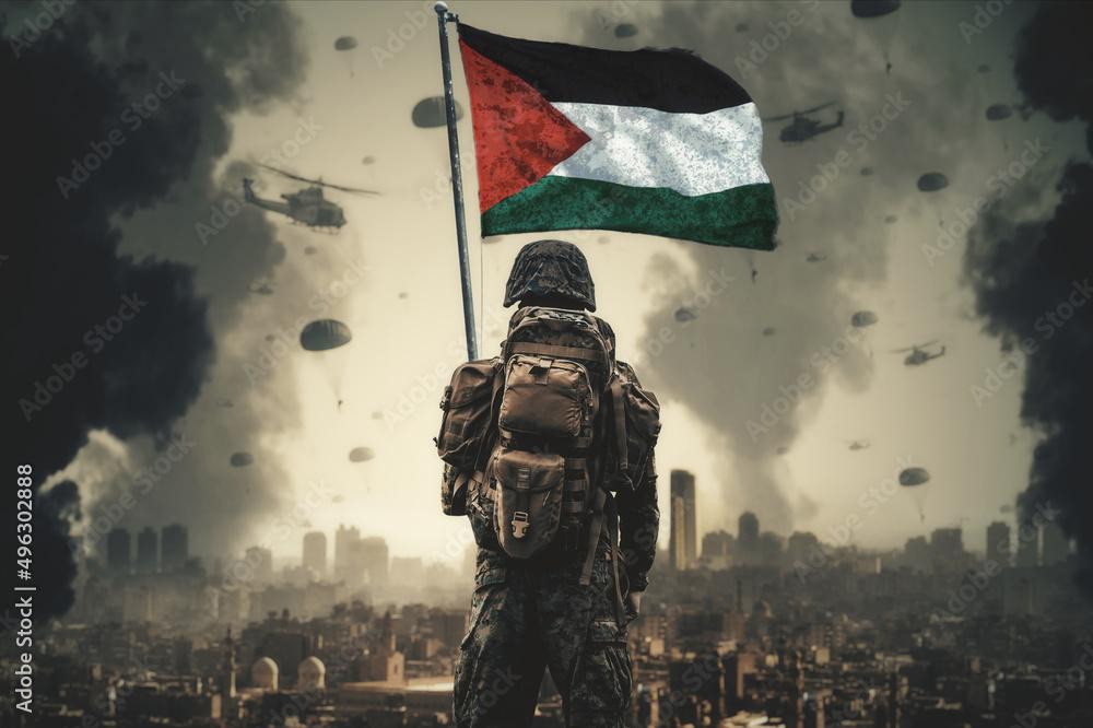 A Soldier Stands With Palestine Flag In His Hand And Looks At