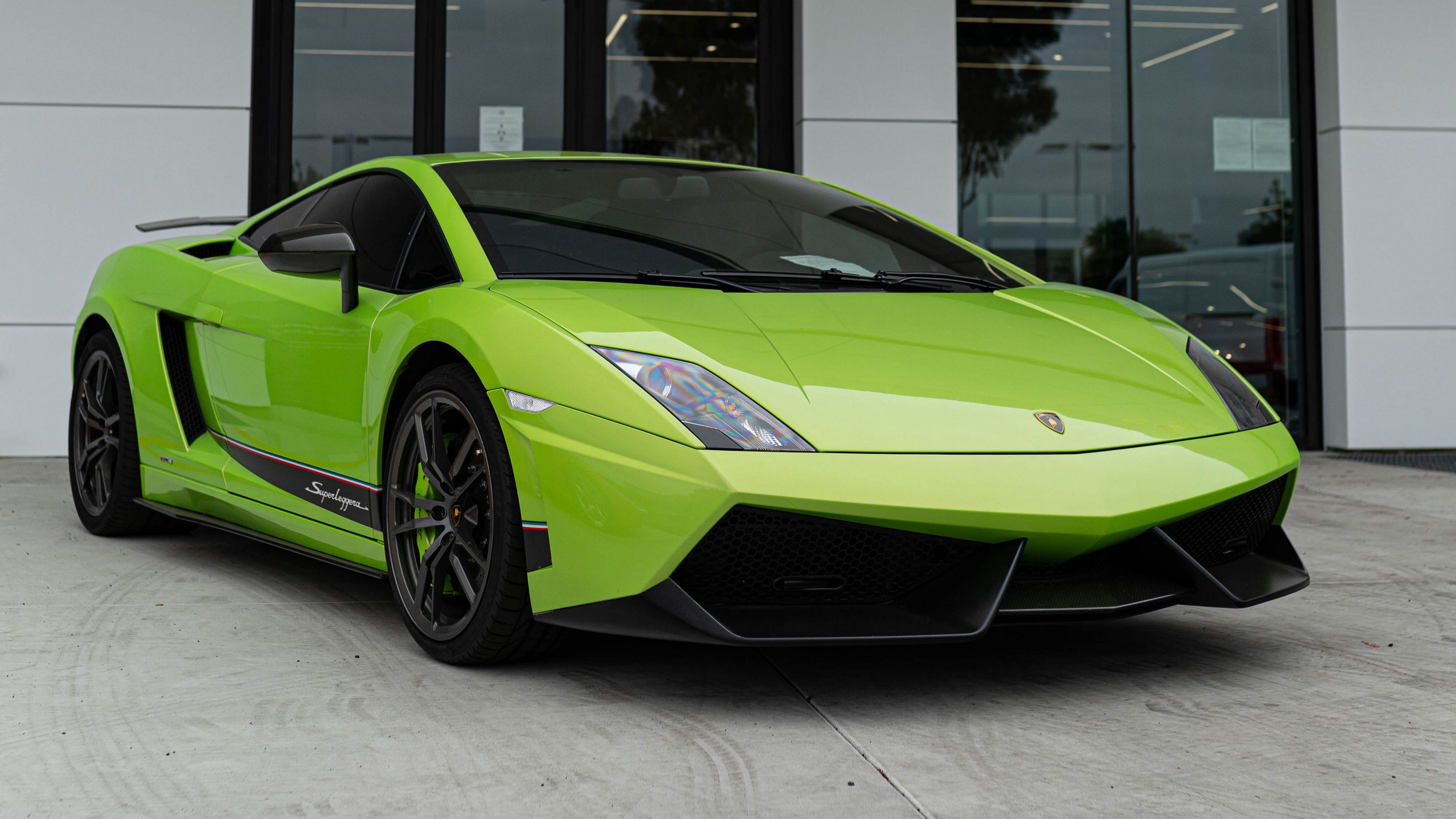 Lime Green Lamborghini Gallardo Superleggera parked in front of a dealership