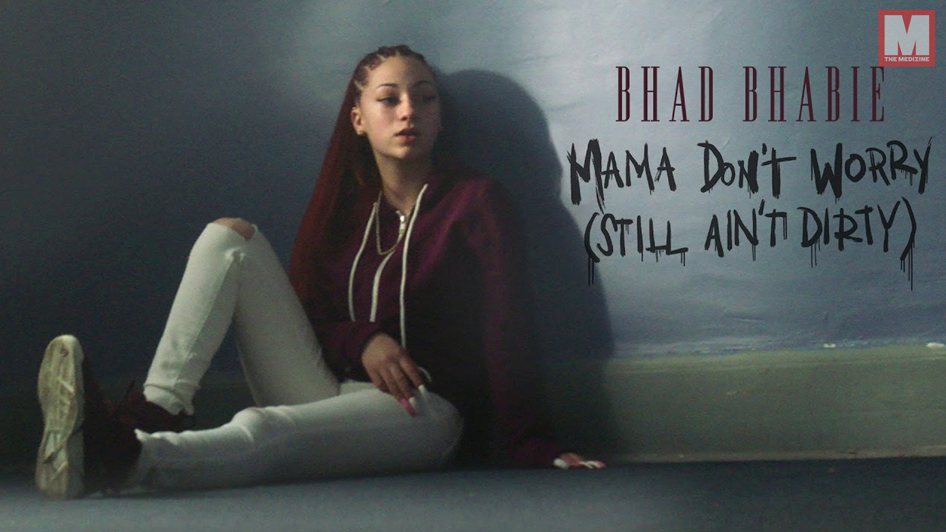 Bhad Bhabie sitting against a wall in a promotional image for her song 