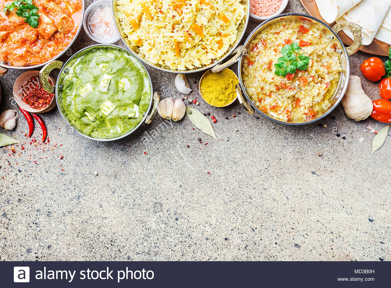 Different Bowls With Assorted Indian Food On Gray Stone Background