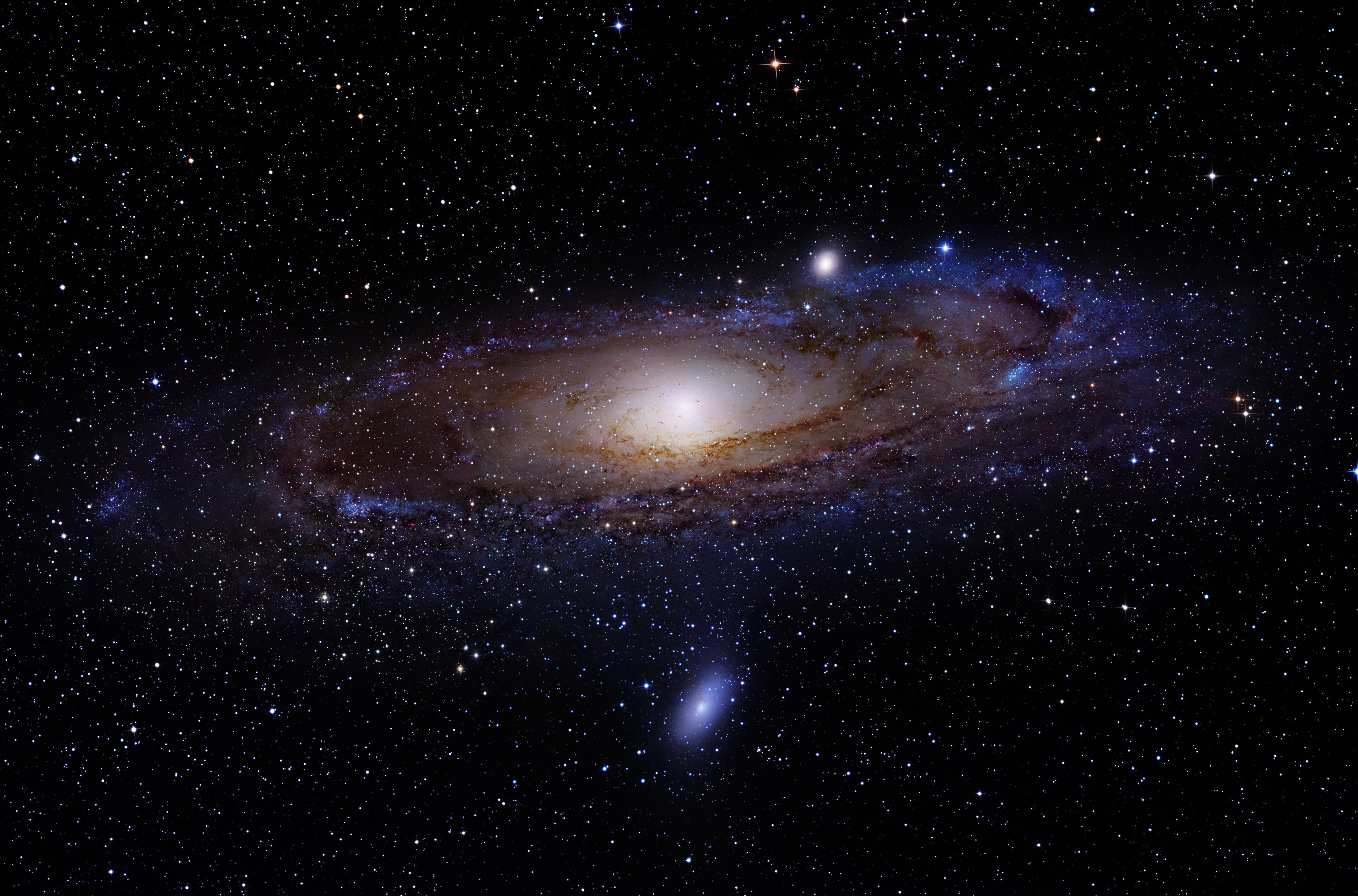 A breathtaking panoramic view of a spiral galaxy, showcasing its swirling arms of stars, gas, and dust against the backdrop of the vast, dark expanse of space