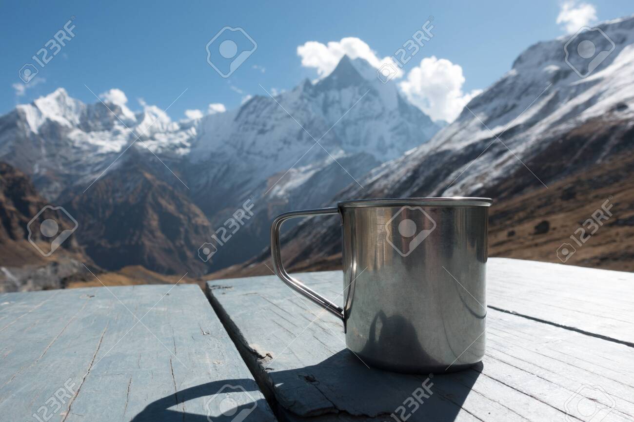Cup On Table With Himalaya Mountains In The Background Showcasing
