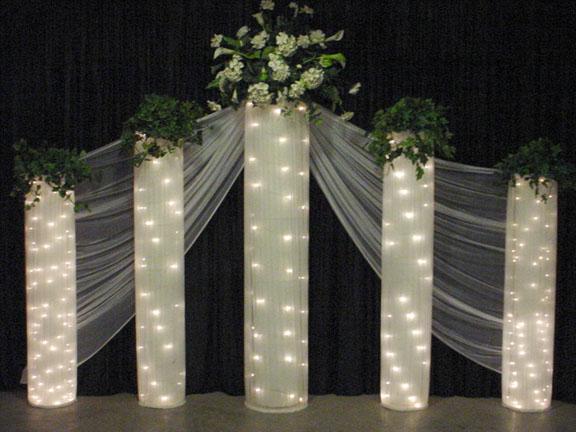 French Doors Backdrop Accented With Lighted Columns And Greenery