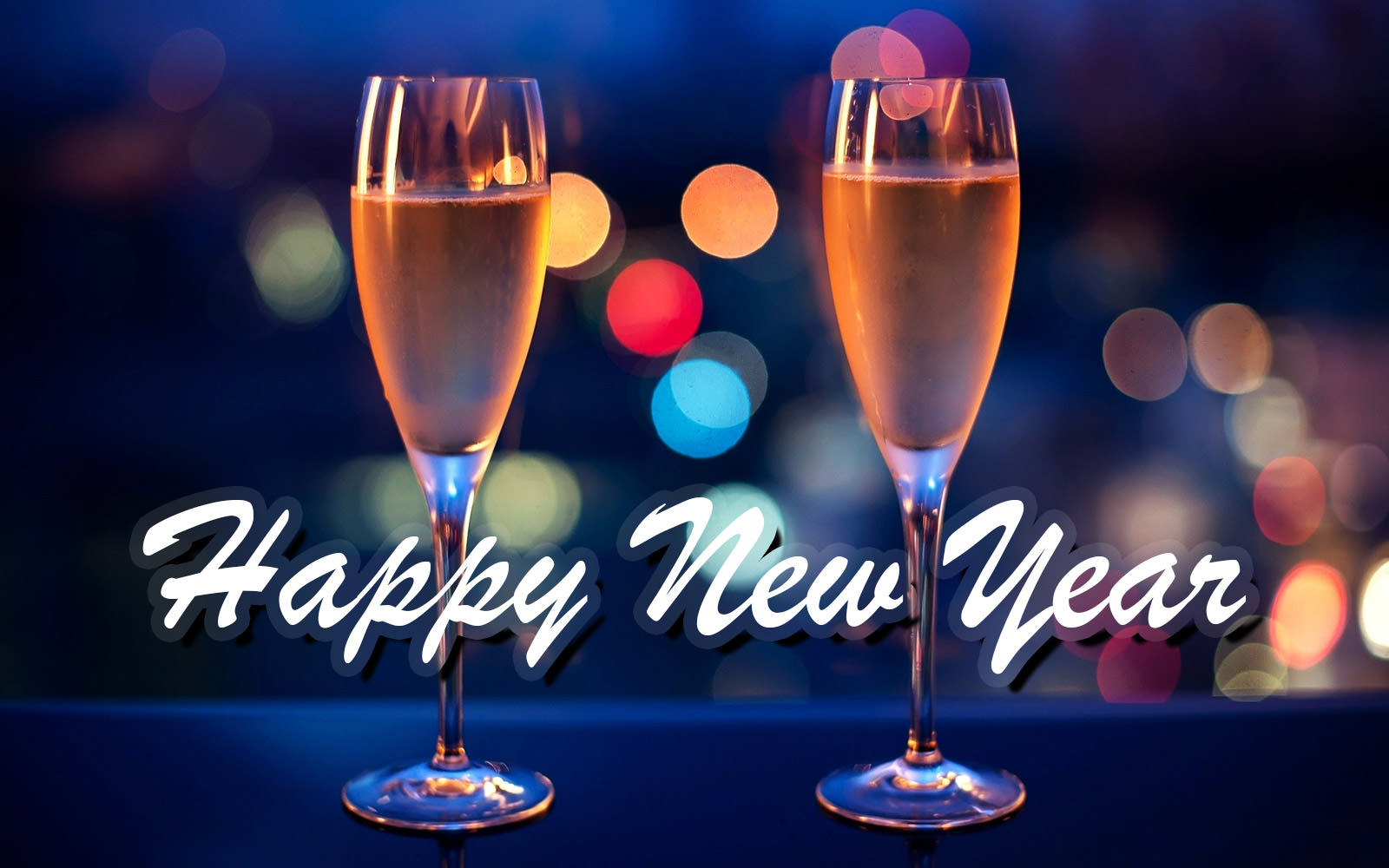 Two champagne flutes filled with bubbly, against a backdrop of colorful city lights at night. Text overlay reads 'Happy New Year'