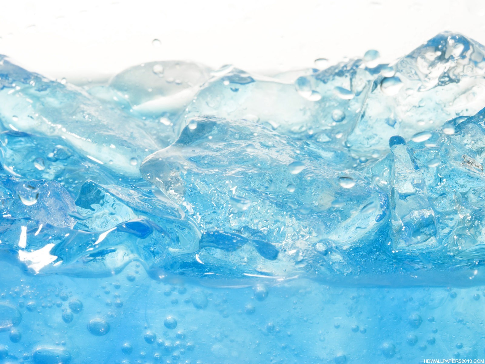 Close-up of ice cubes in light blue water, creating a refreshing and cool visual