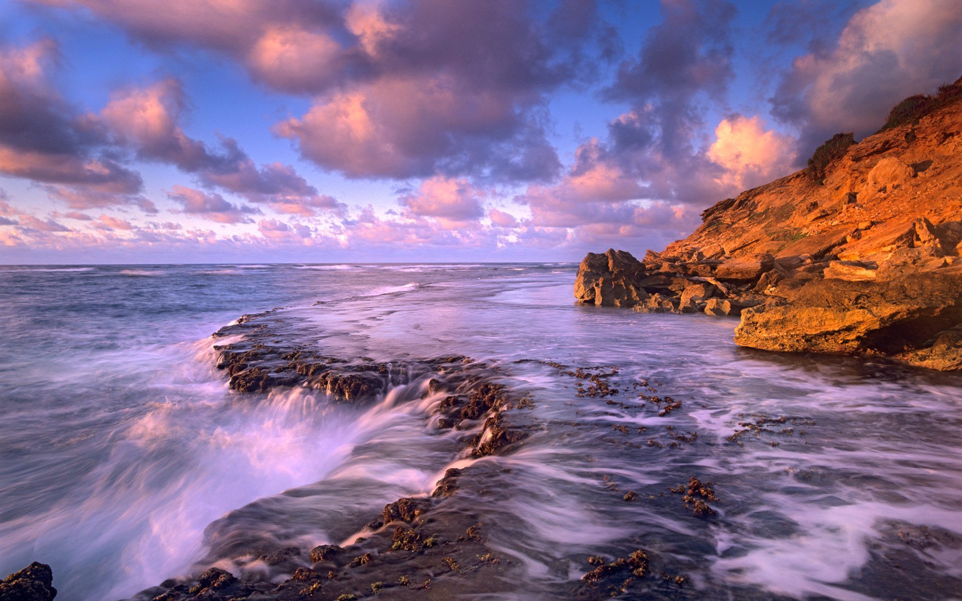 Rocky coastline at sunset, a classic Windows wallpaper
