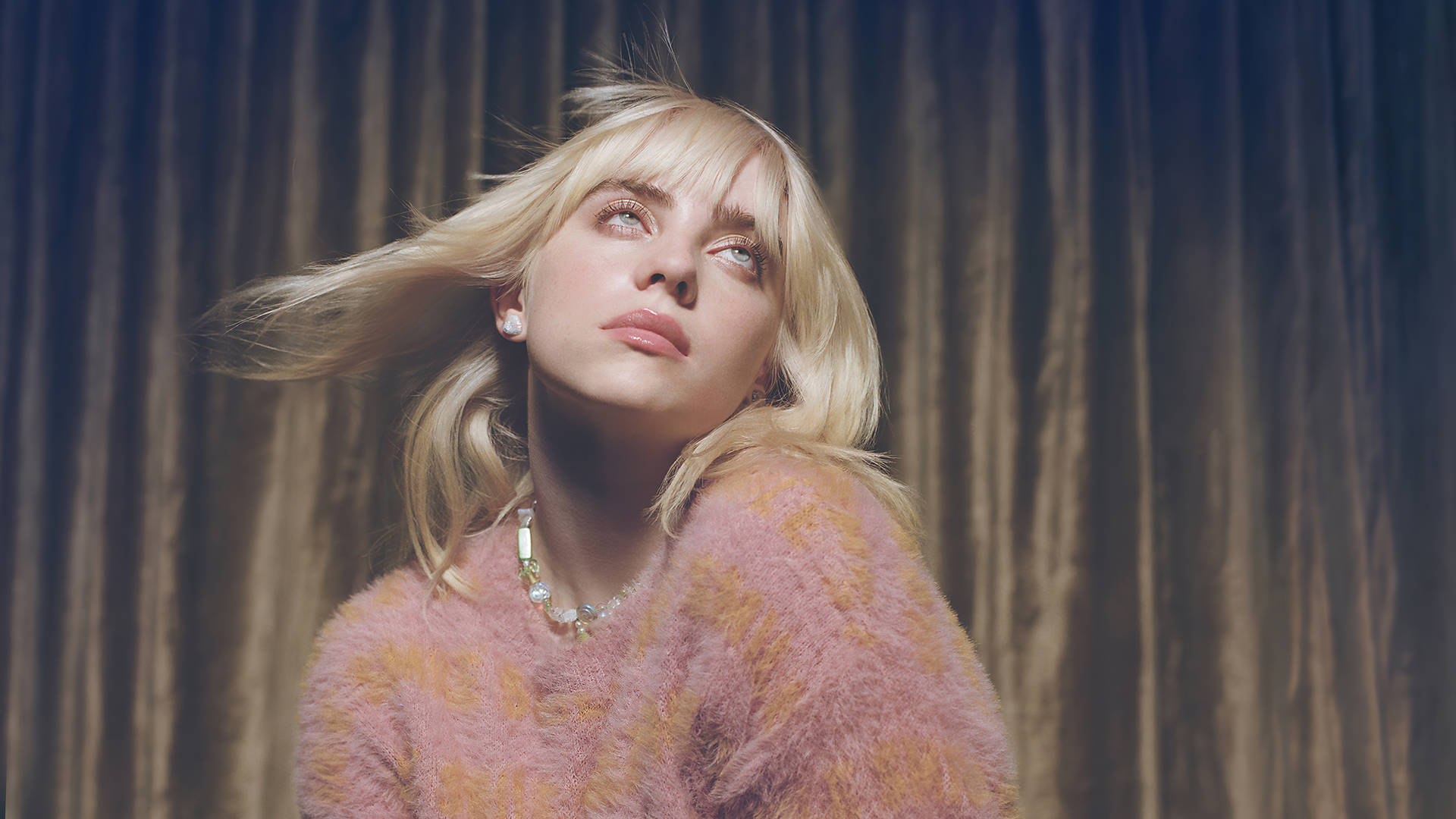 Billie Eilish HD Wallpaper: Close-up portrait against a textured backdrop