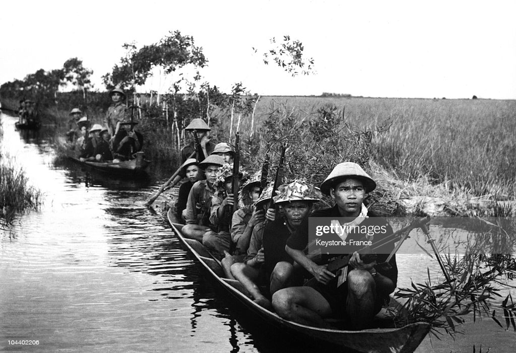 A Group Of Viet Cong Patrolling In Rice Paddy The American