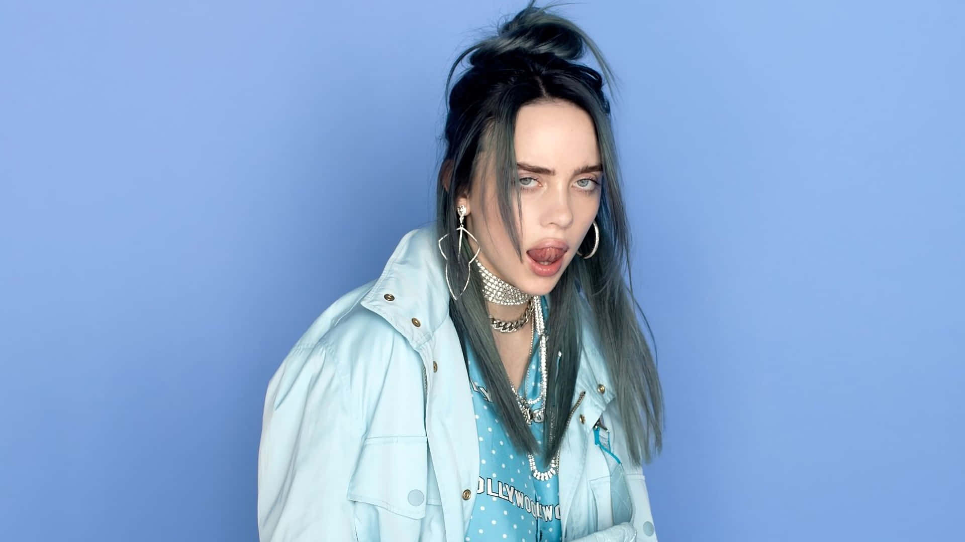 Billie Eilish With Her Laptop In A Cozy Home Setting Wallpaper