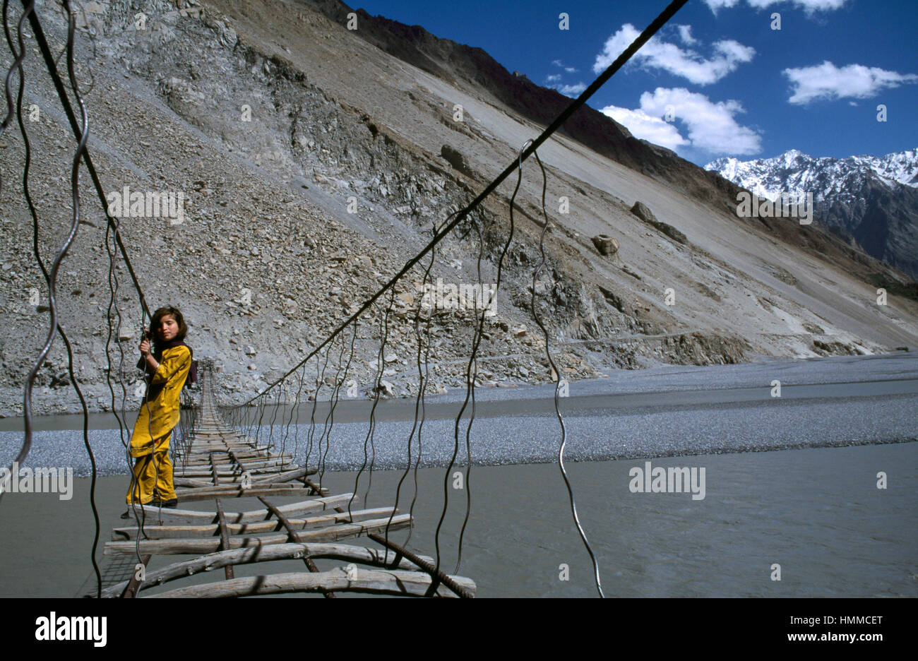 Girl On Suspension Bridge At Passu Village Upper Hunza Valley