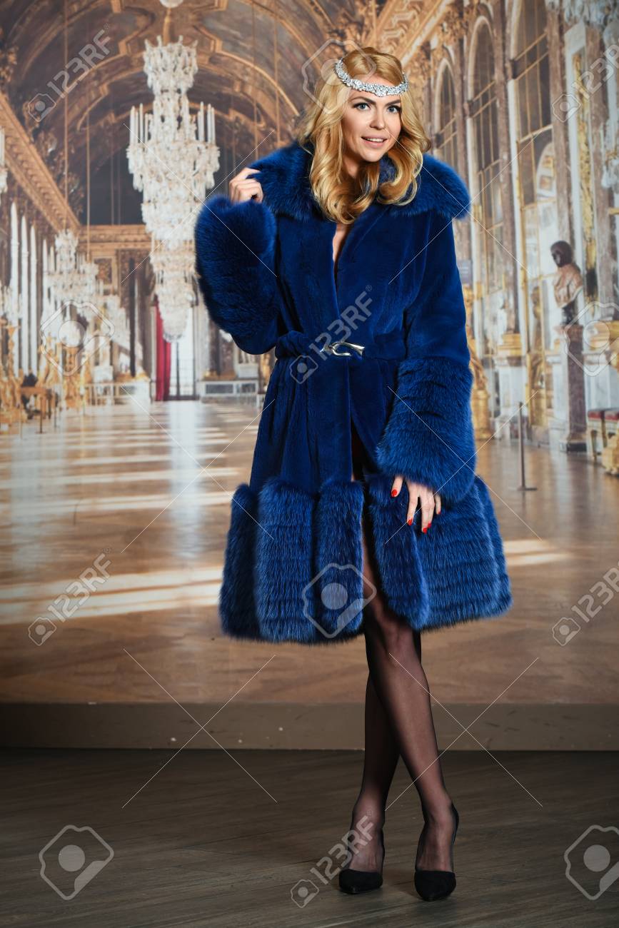 Tall Blond Model Posing Wearing Lingerie And Blue Fur Coat In