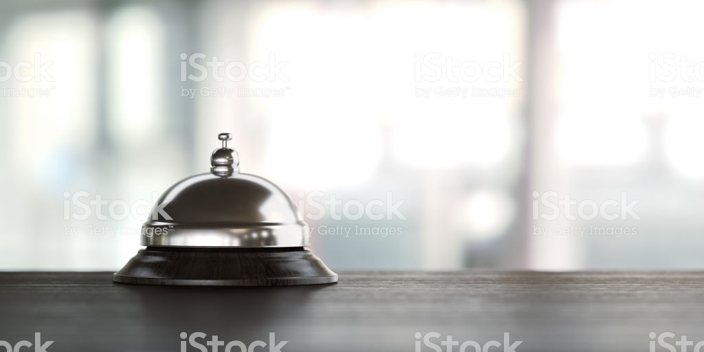 Concierge Bell On Wood Desk Over Defocused Background Stock Photo