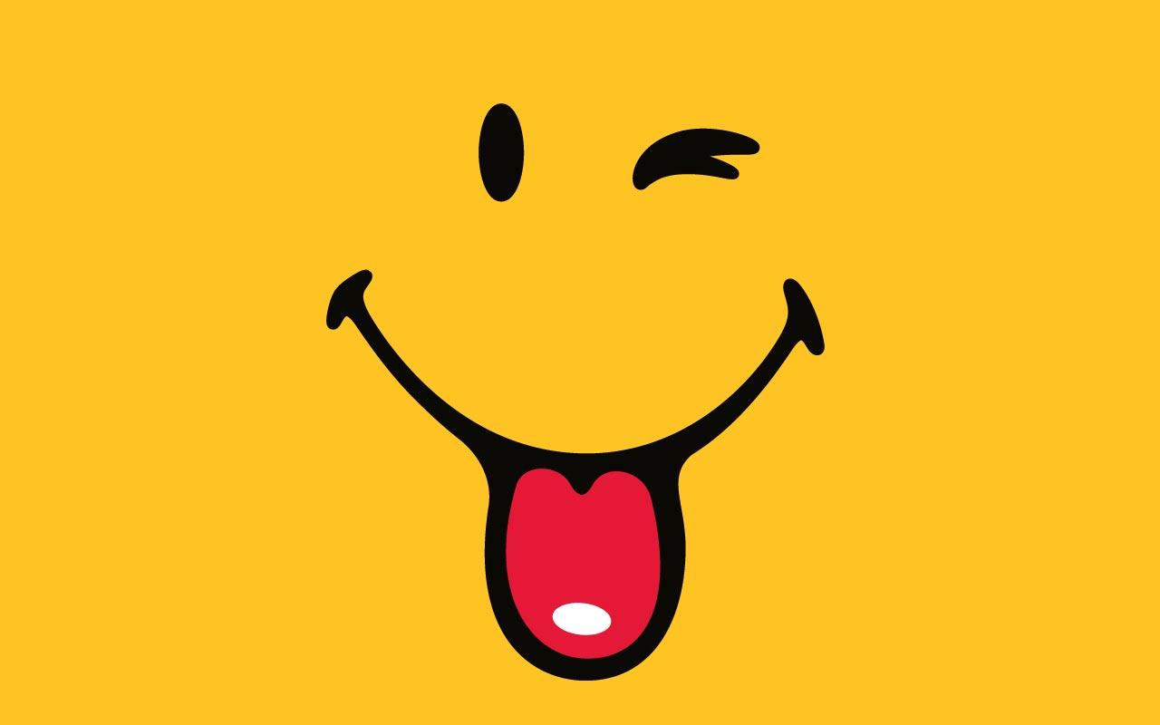 A classic yellow smiley face with a cheerful wink and its tongue sticking out, conveying a sense of playful mischief and happiness