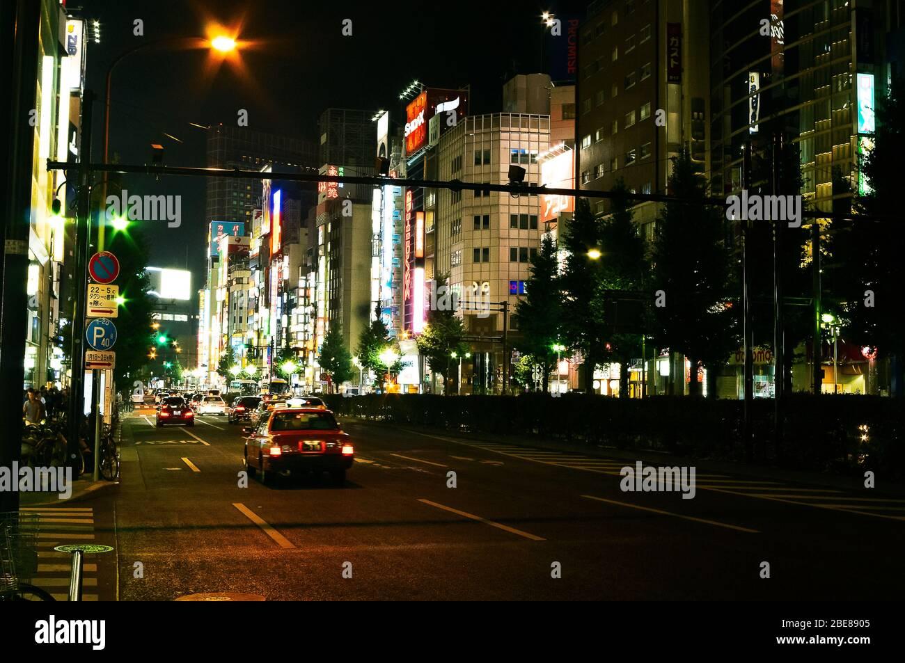 Night time Street scene showing the neon lighting of the Shinjuku