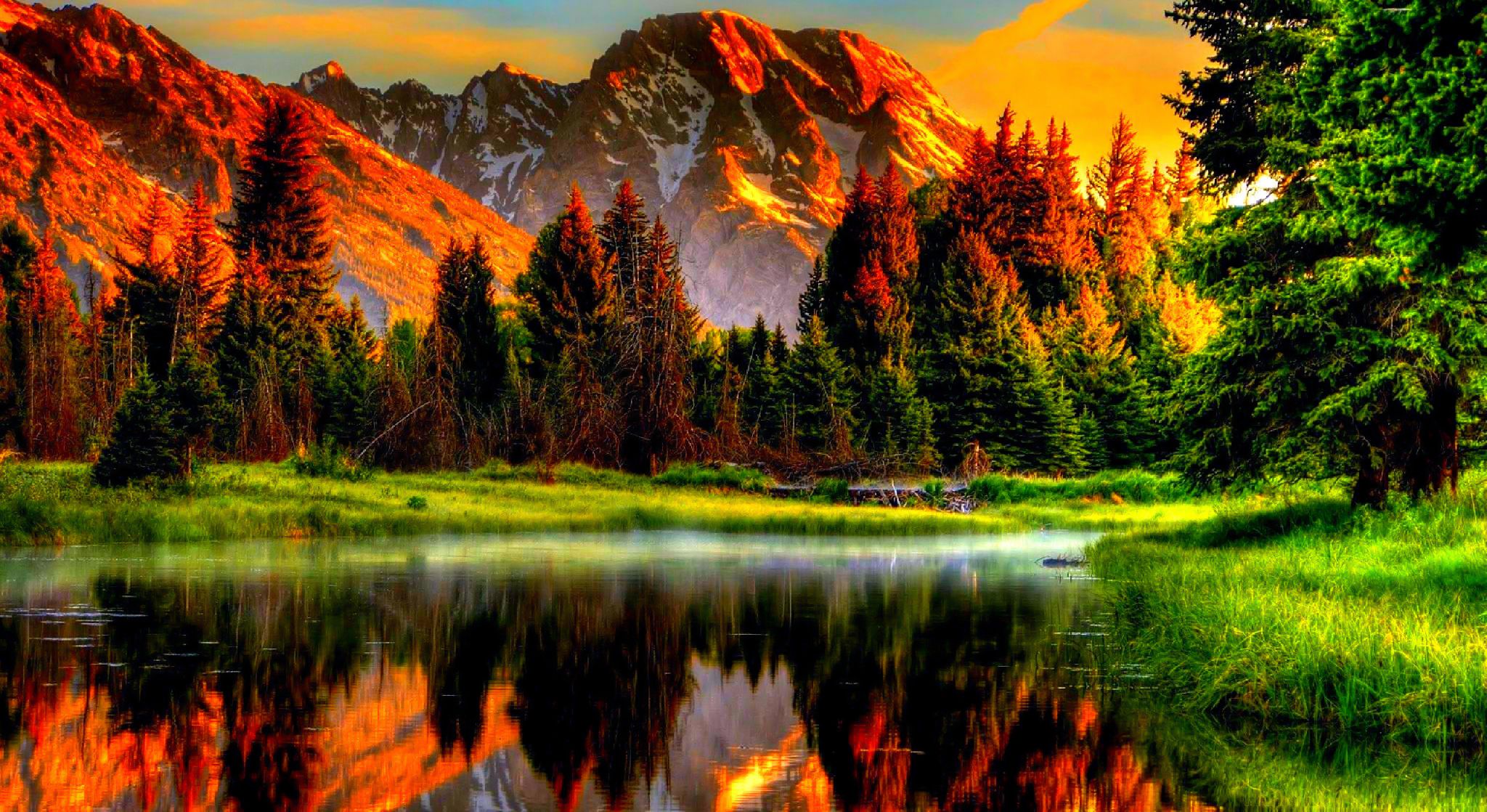 Stunning autumn scenery reflected in a calm lake with majestic mountains at sunset