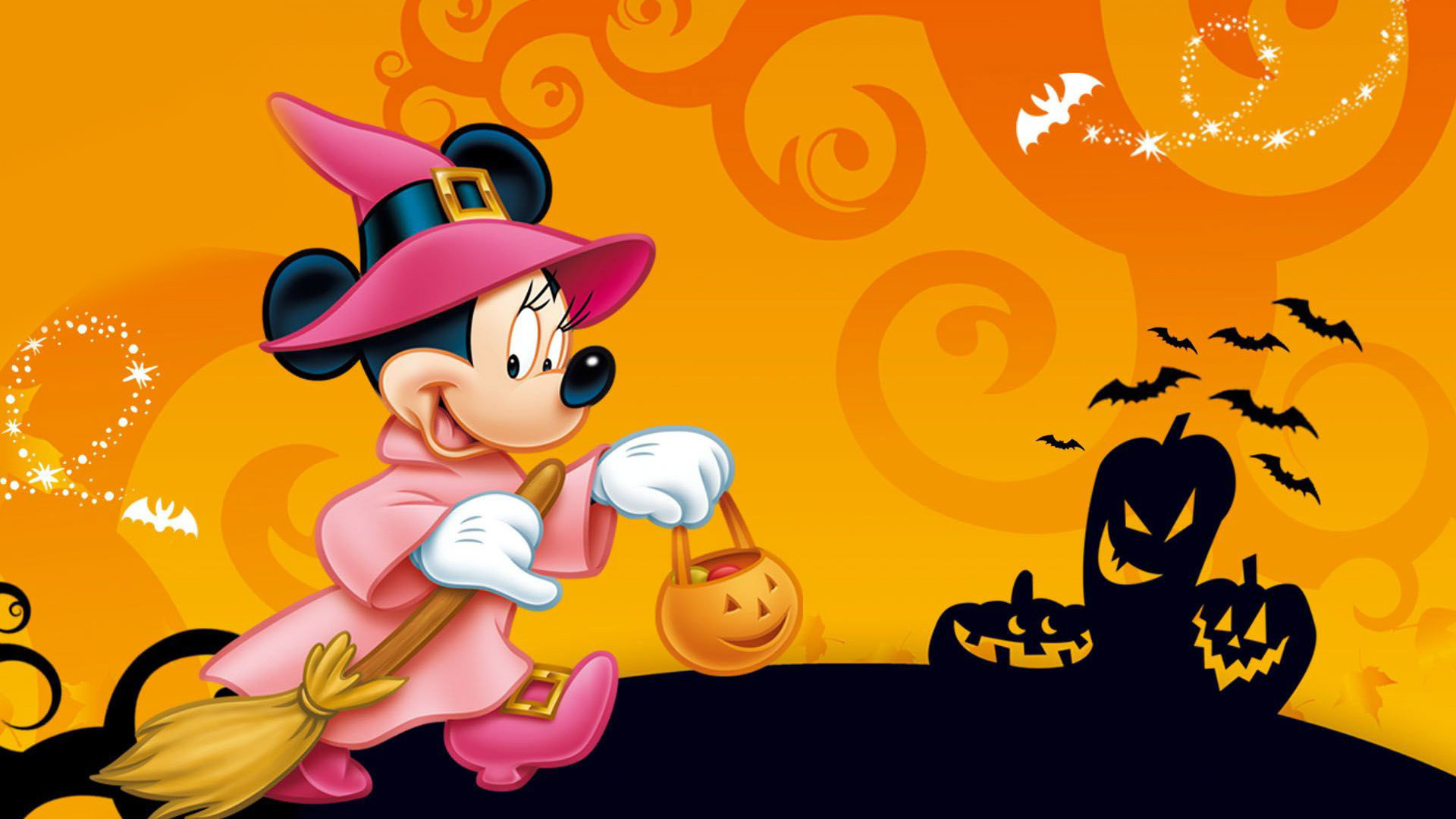Minnie Mouse dressed as a witch for Halloween trick-or-treating, against an orange background with spooky carved pumpkins and bats