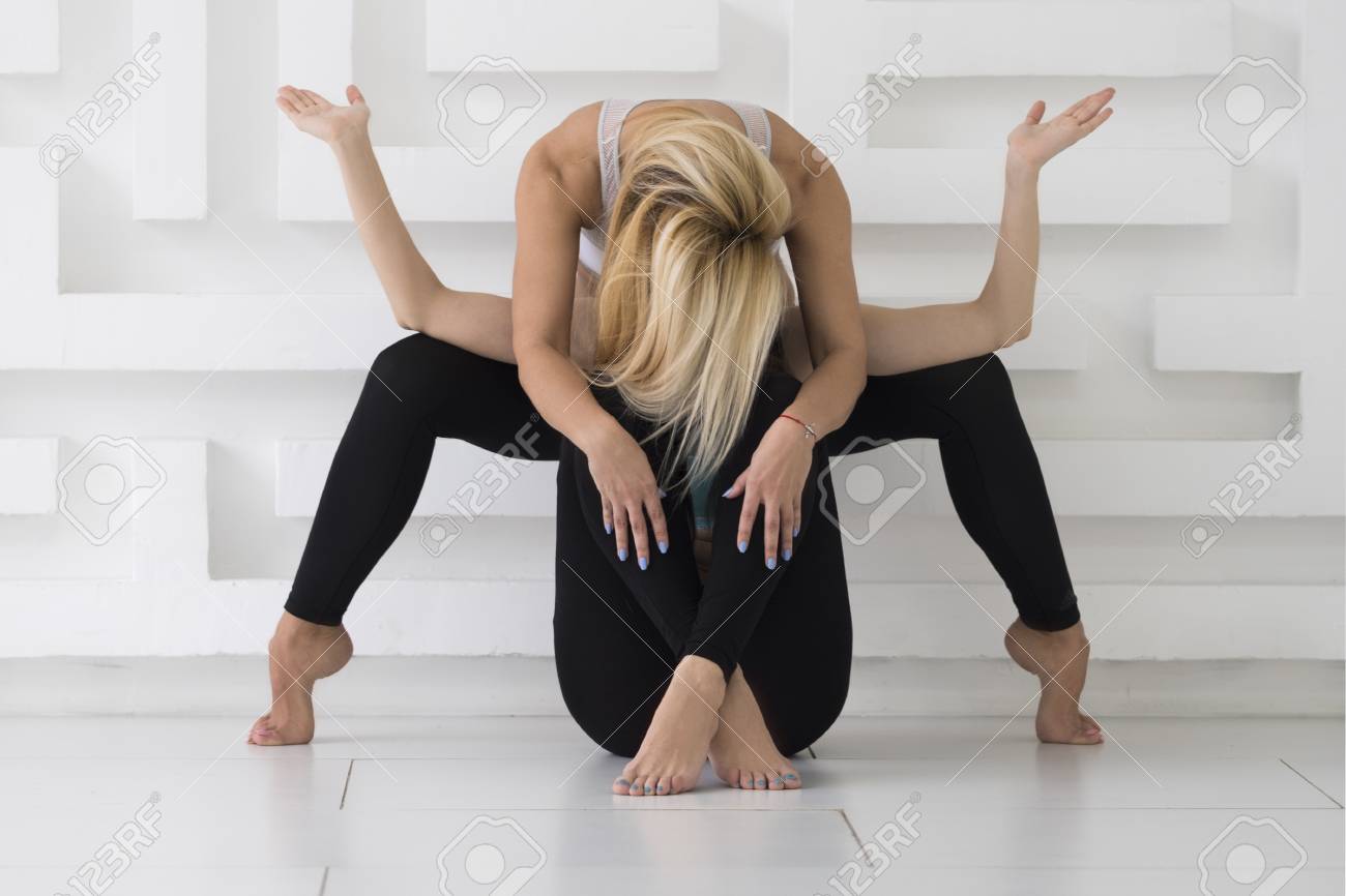 Two Young Women Practicing Acro Yoga Balance Pose Whate
