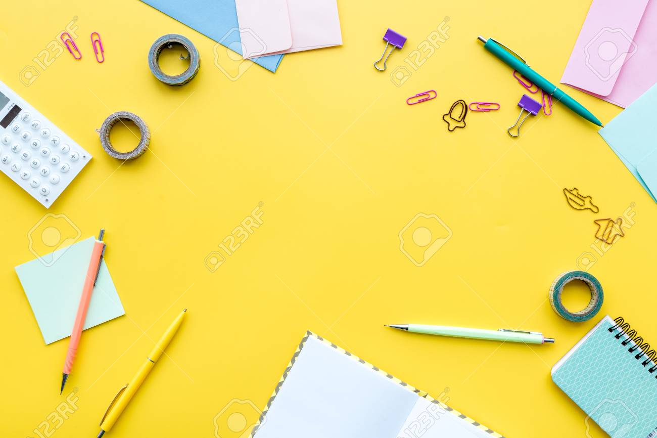 Scattered Stationery On Student S Desk Yellow Background Top