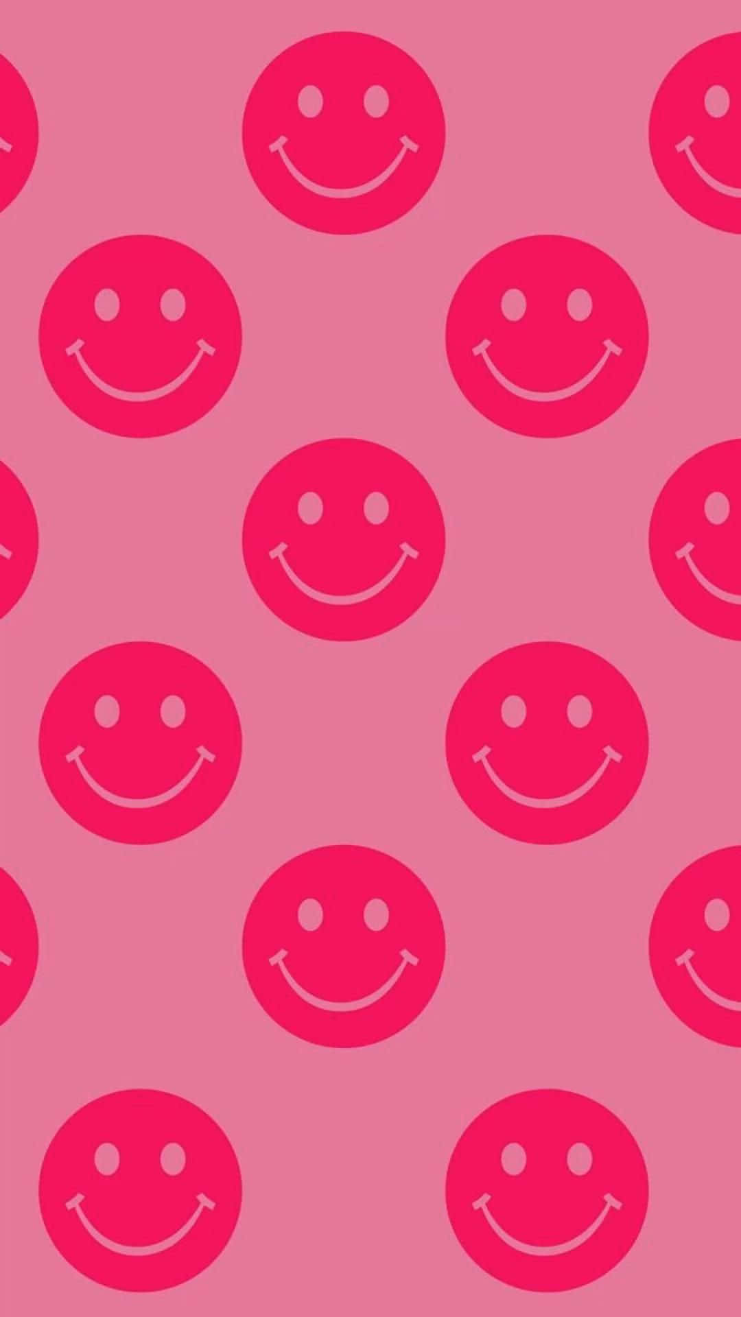 A seamless pattern of bright pink smiley faces on a lighter pink background