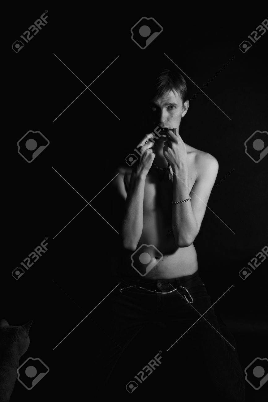 Young Slender Naked Man On A Black Background Stock Photo Picture