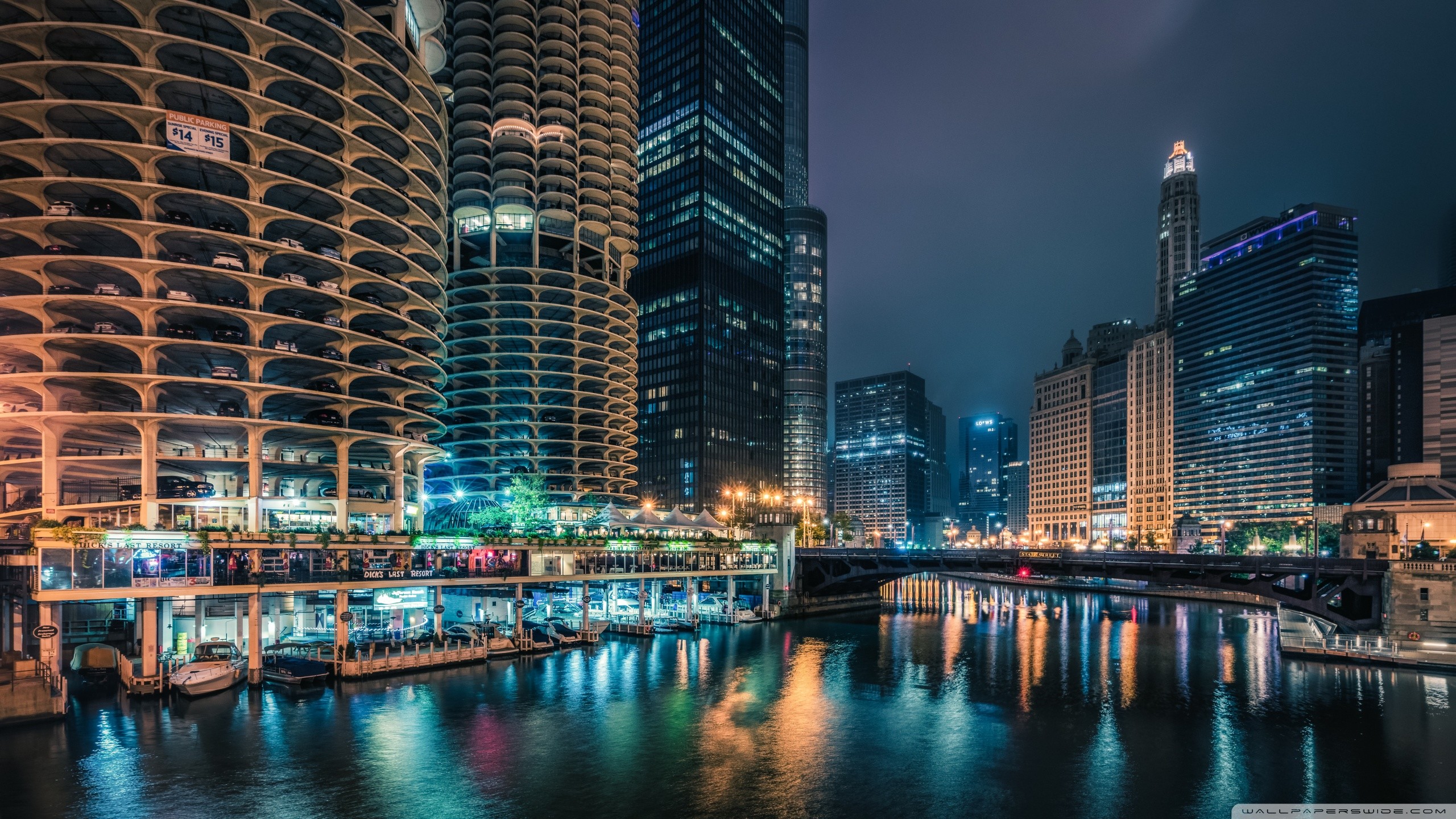 Stunning night view of the Chicago skyline with the Chicago River and Marina City in the foreground