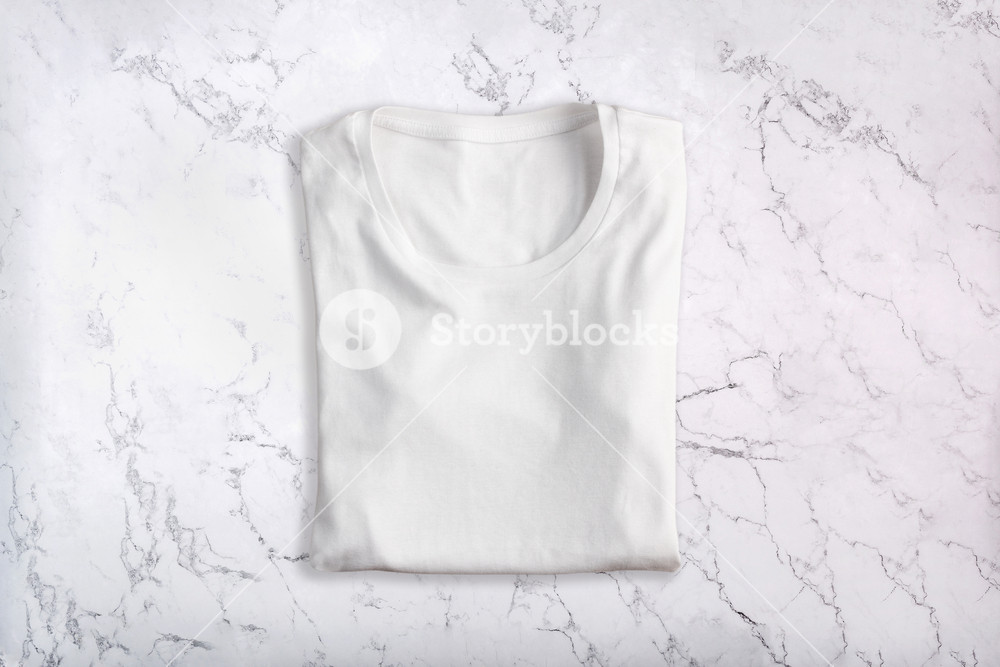 White Folded T Shirt On Marble Background Flat Lay Top